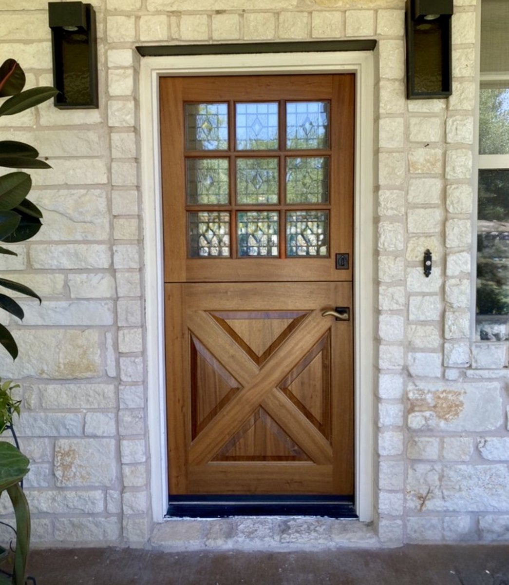 Custom Dutch door with leaded glass on stone facade